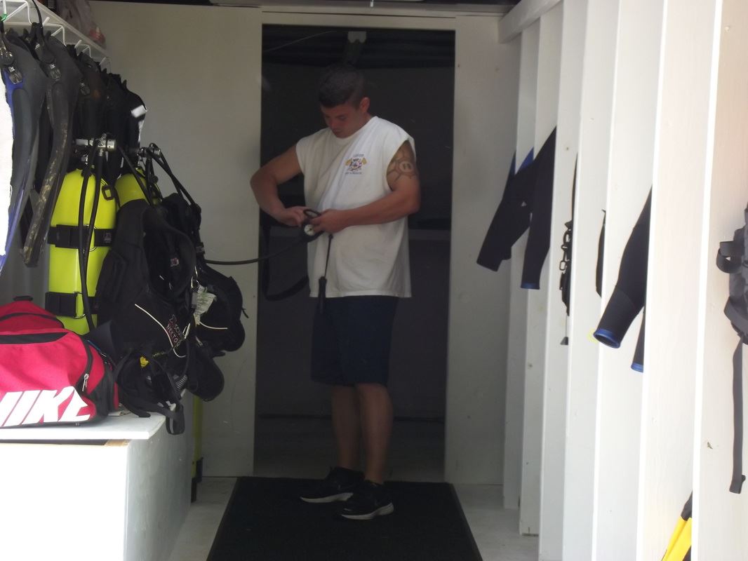 A diver preparing and inspecting their gear